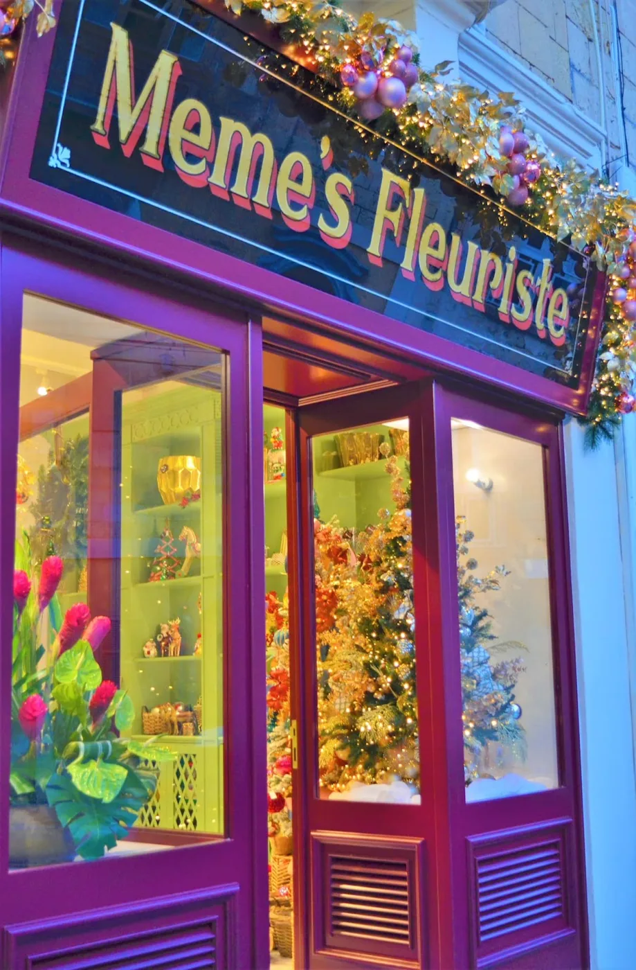 The aubergine shopfront of Meme's Fleuriste with its gold sign
